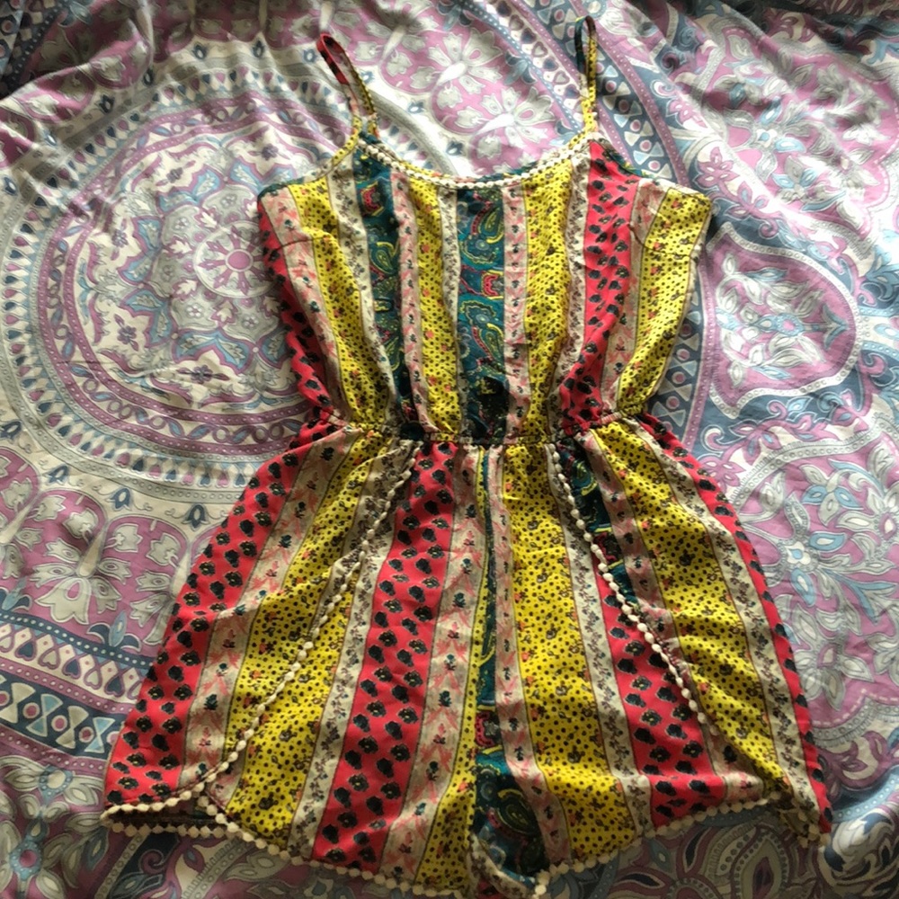 Colorful printed romper with cream colored frills!